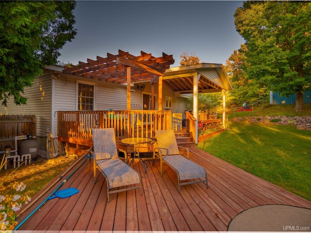 deck featuring a lawn and a pergola