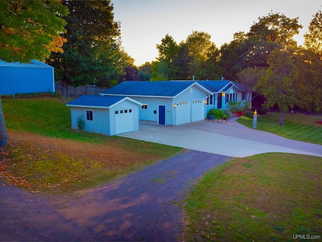 single story home with a garage and a lawn