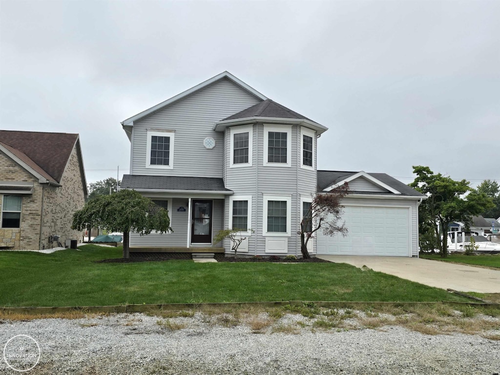 view of front of house with a garage and a front yard