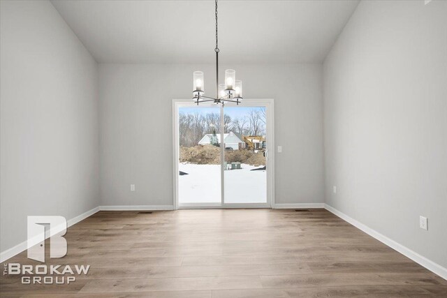 1440 Lincoln St, Lapeer, MI 48446 - unfurnished dining area featuring a chandelier, wood finished floors, and baseboards
