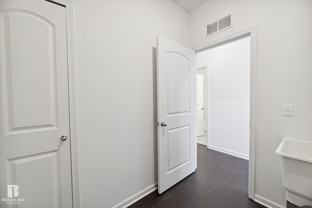 corridor with dark hardwood / wood-style flooring