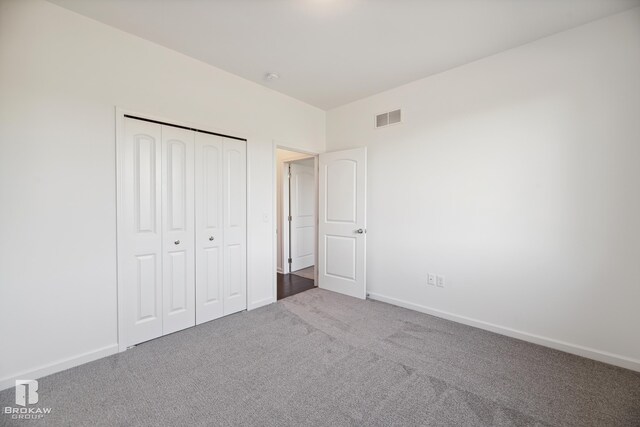 unfurnished bedroom featuring a closet and carpet floors