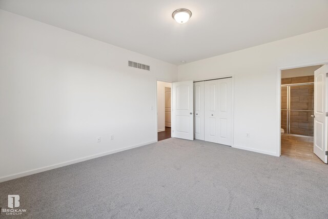 unfurnished bedroom with carpet floors and a closet