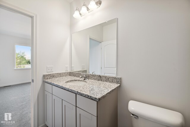 bathroom featuring toilet and vanity