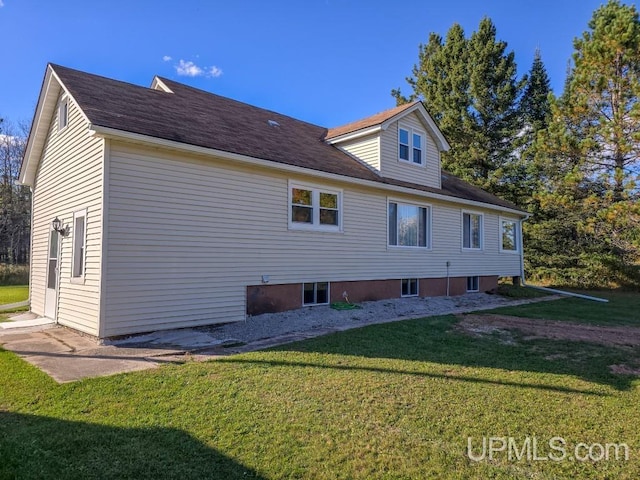 view of property exterior with a lawn