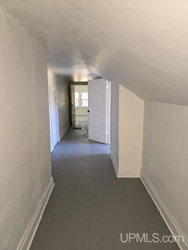 hallway featuring vaulted ceiling