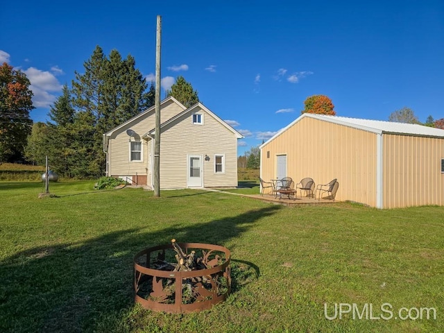 rear view of house featuring a lawn