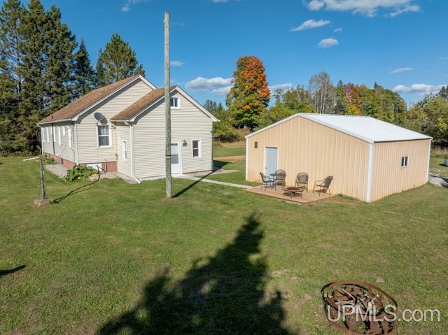 back of house with a lawn and a patio area