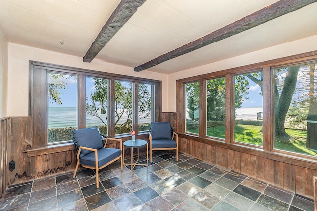 sunroom / solarium featuring a wealth of natural light, a water view, and beamed ceiling