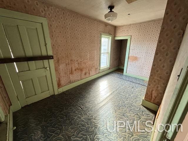 empty room featuring ornamental molding