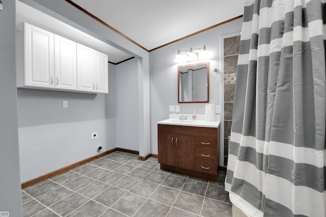 bathroom with ornamental molding, tile patterned flooring, and vanity