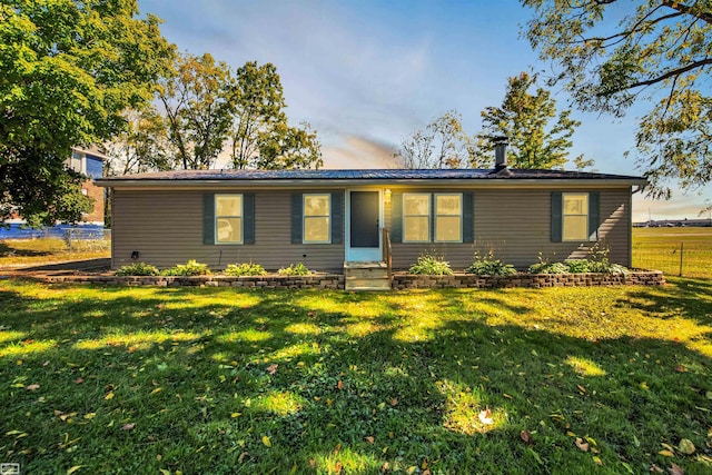 single story home with a front lawn