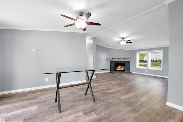 unfurnished living room featuring ceiling fan, hardwood / wood-style floors, and ornamental molding