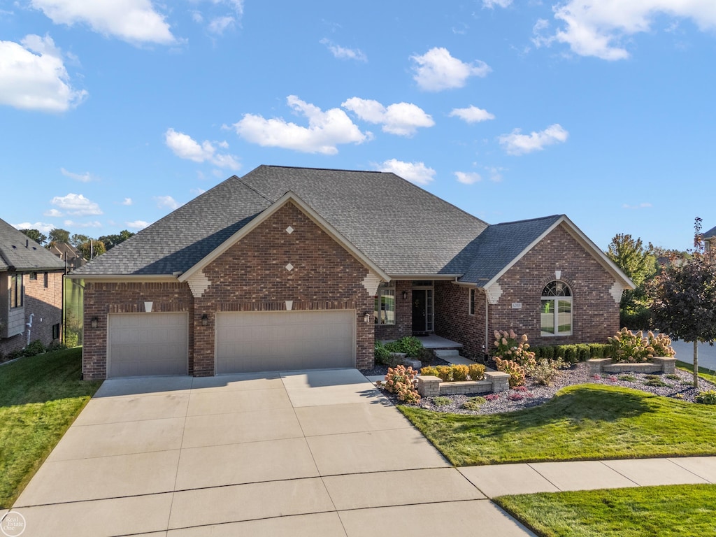 view of front of home featuring a garage and a front yard