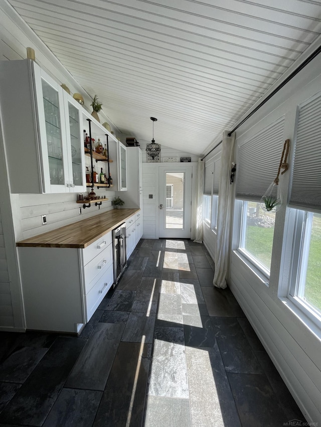 interior space with beverage cooler and vaulted ceiling