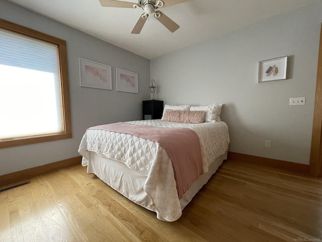 bedroom with light hardwood / wood-style flooring and ceiling fan