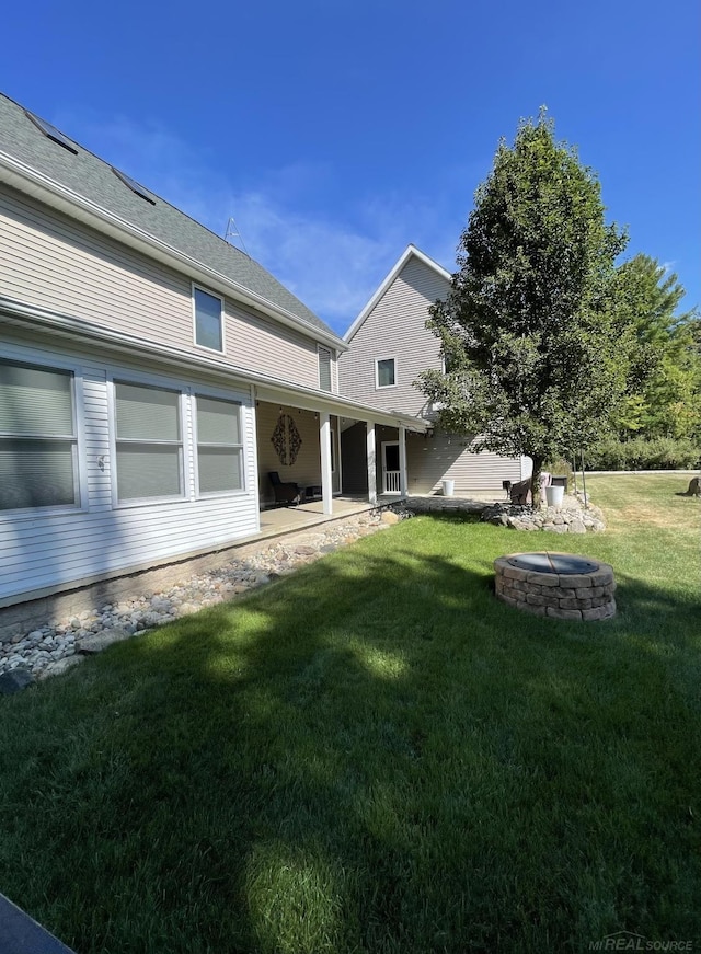 view of yard featuring an outdoor fire pit and a patio area