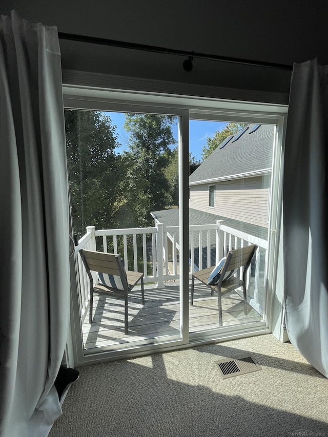 doorway to outside featuring carpet floors