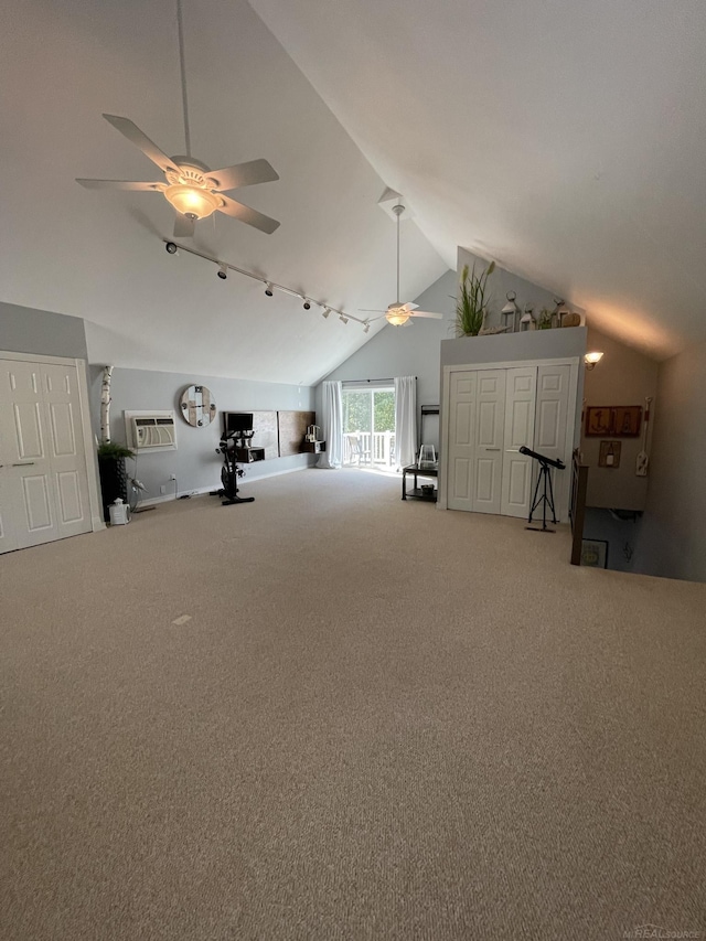 interior space featuring ceiling fan, lofted ceiling, carpet, and a wall unit AC