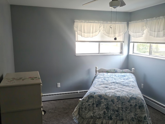 carpeted bedroom with ceiling fan and baseboard heating