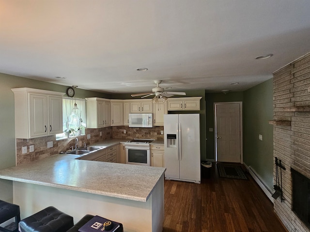 kitchen with dark wood-type flooring, tasteful backsplash, white appliances, kitchen peninsula, and ceiling fan