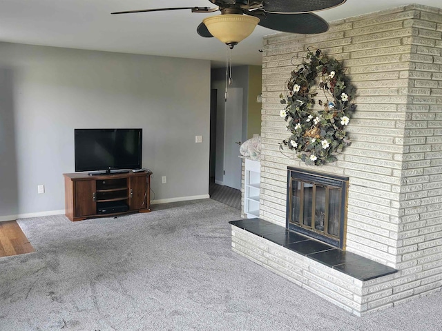 unfurnished living room with carpet, a fireplace, and ceiling fan