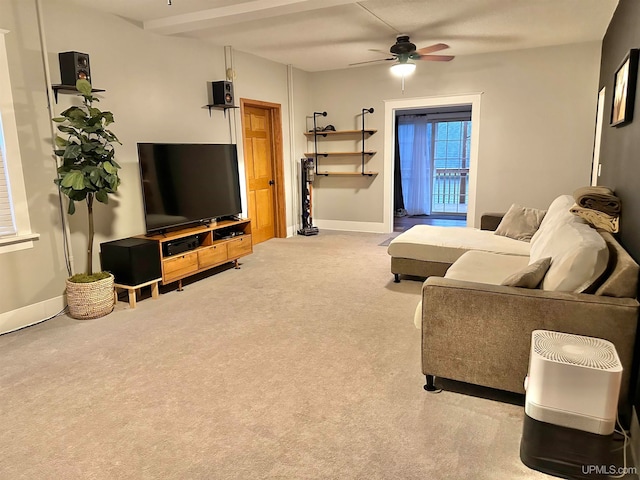 carpeted living room with beam ceiling and ceiling fan