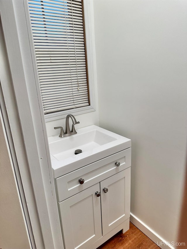 bathroom with vanity and hardwood / wood-style floors