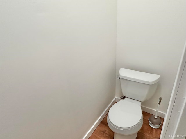 bathroom with wood-type flooring and toilet