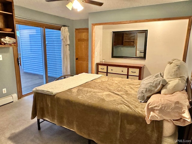 bedroom featuring ceiling fan, carpet flooring, a textured ceiling, a baseboard radiator, and access to exterior