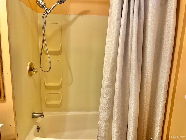 bathroom with shower / bathtub combination with curtain