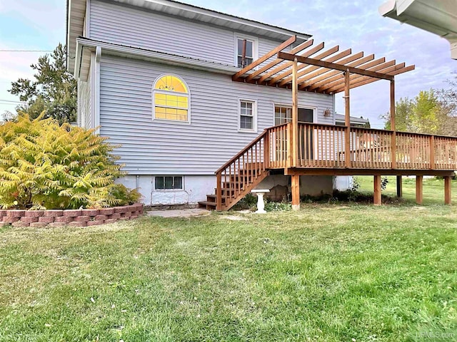 back of house with a pergola, a wooden deck, and a yard