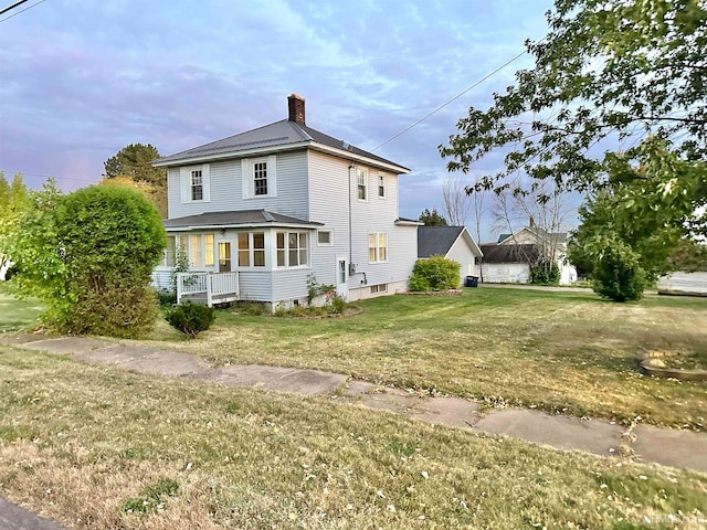 back of property featuring a yard