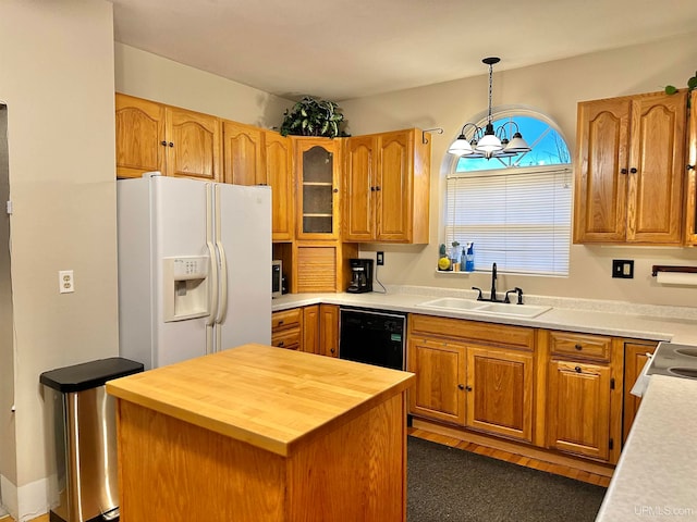 kitchen featuring sink, a kitchen island, a chandelier, white refrigerator with ice dispenser, and black dishwasher