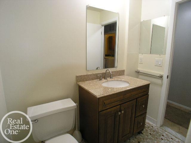 bathroom featuring vanity and toilet