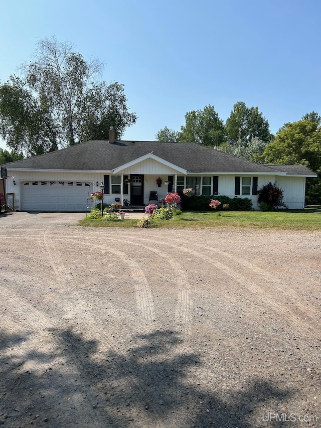 ranch-style house with a porch and a garage