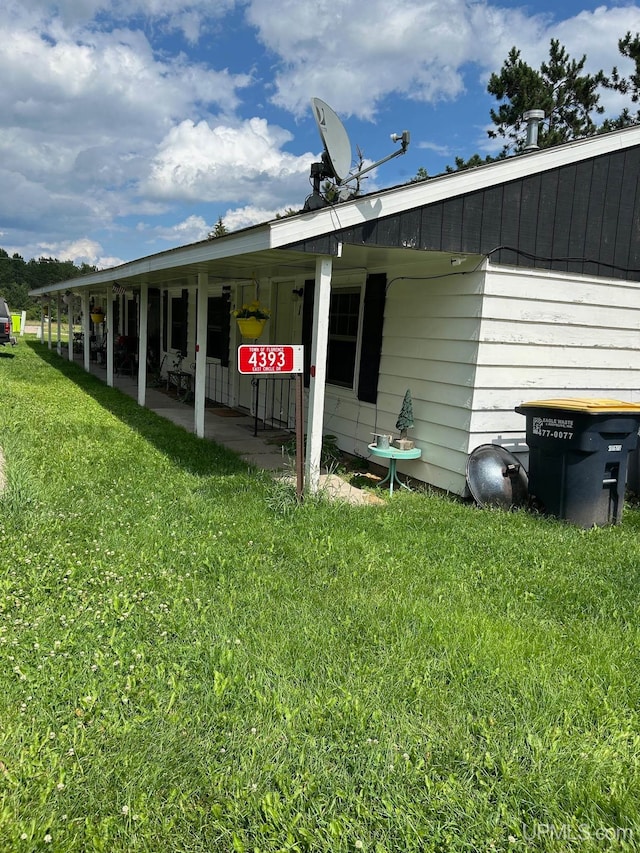 view of side of home with a yard