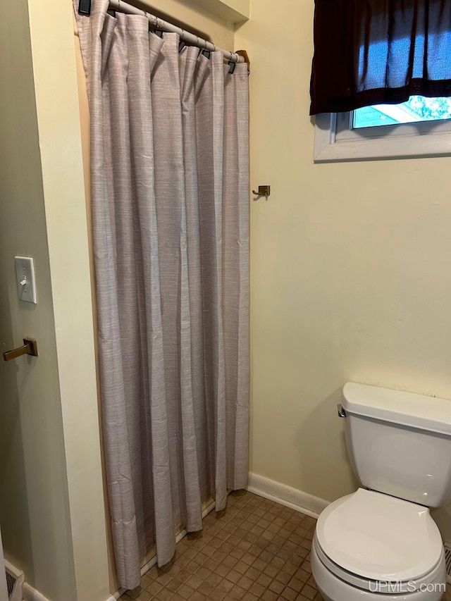 bathroom featuring tile patterned flooring and toilet