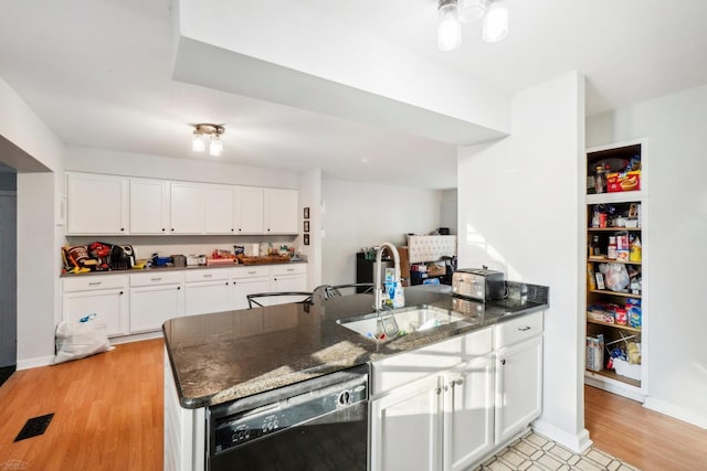 kitchen featuring white cabinets, black dishwasher, light hardwood / wood-style floors, and sink