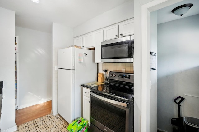 kitchen with white cabinetry, stainless steel appliances, and tasteful backsplash