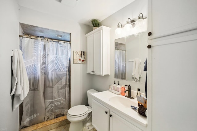 bathroom with vanity, toilet, and tile patterned floors