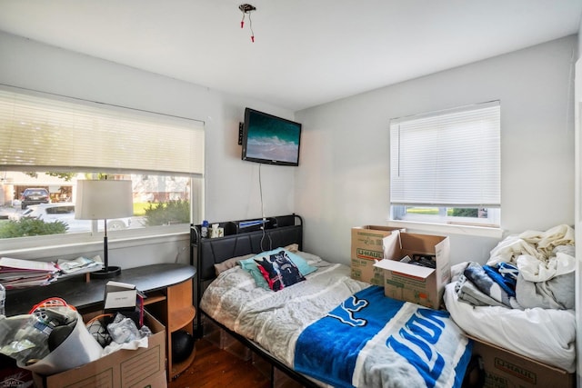 bedroom with wood-type flooring and multiple windows