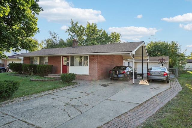 view of front of house featuring a garage, a front lawn, and a carport