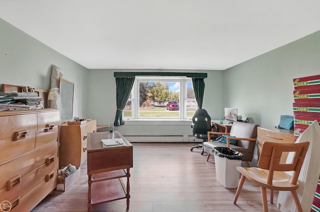 home office featuring a baseboard heating unit and light hardwood / wood-style floors