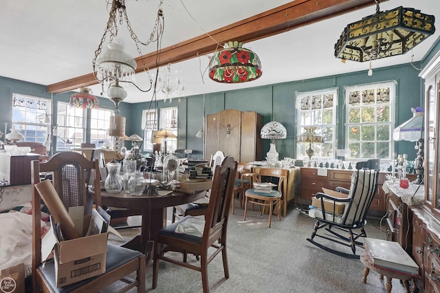 dining room with carpet floors, beamed ceiling, and a wealth of natural light