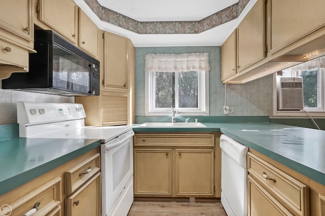 kitchen featuring cooling unit, sink, light hardwood / wood-style floors, and white appliances