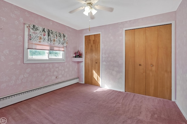 unfurnished bedroom with ceiling fan, baseboard heating, and carpet flooring