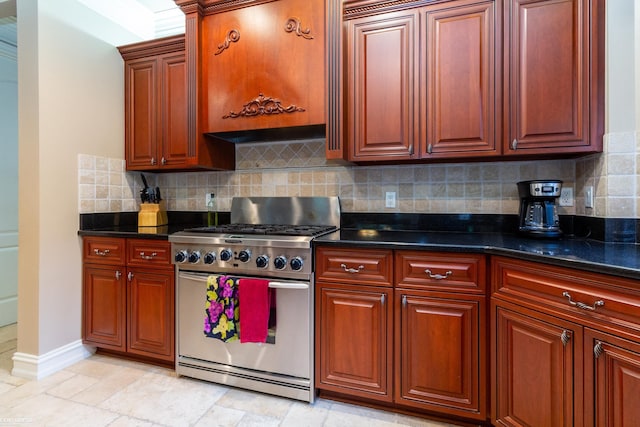 kitchen with stainless steel stove, dark stone counters, crown molding, and decorative backsplash