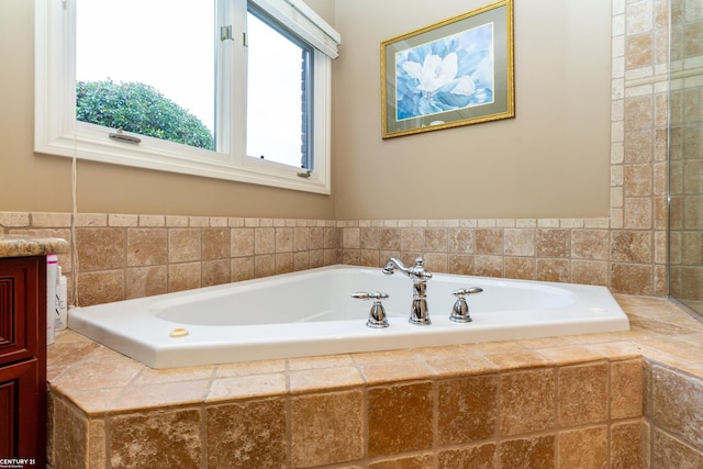 bathroom featuring a relaxing tiled tub