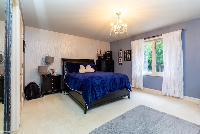 bedroom featuring a chandelier and light colored carpet